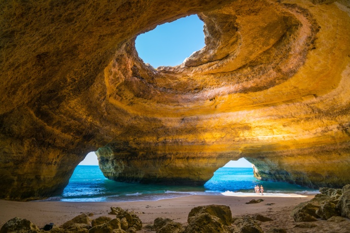 Person standing on rock overlooking Algarve coast